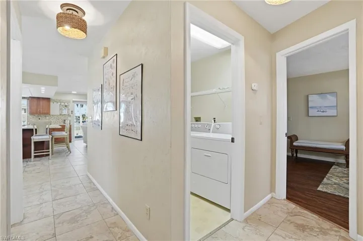 Hall with light marble finish floors and baseboards - Virtually Edited Image