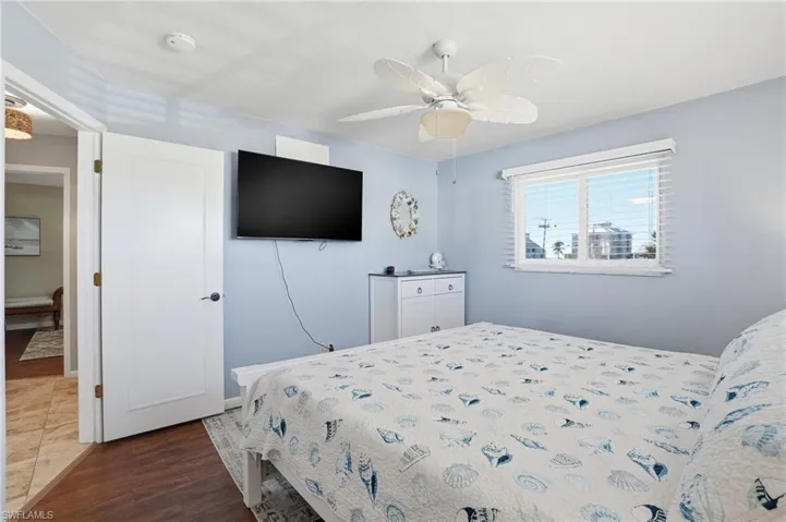 Bedroom with dark wood-type flooring and ceiling fan - Virtually Edited Image