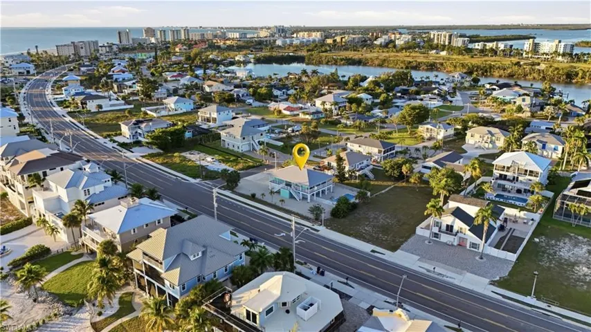 View of property location featuring a nearby body of water and nearby suburban area - Virtually Edited Image
