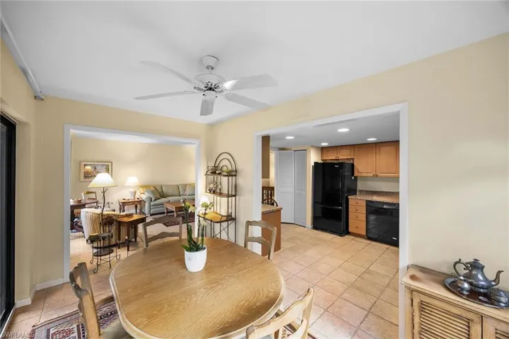 Dining area featuring a ceiling fan, recessed lighting, and light tile patterned floors