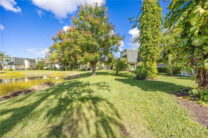 View of green lawn featuring a water view