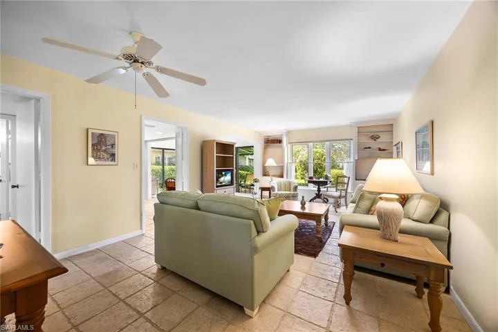 Living room with baseboards and stone tile flooring