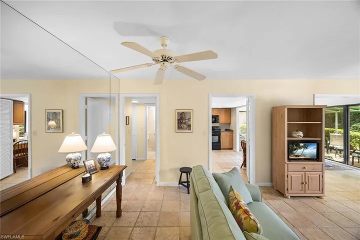 Living room with plenty of natural light and a ceiling fan