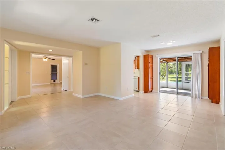 Spare room featuring a textured ceiling, light tile patterned floors, and ceiling fan