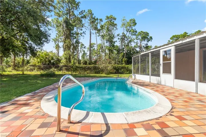 View of pool featuring a yard and a patio