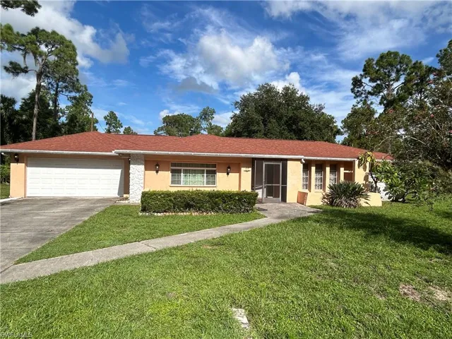 Single story home with a front lawn and a garage