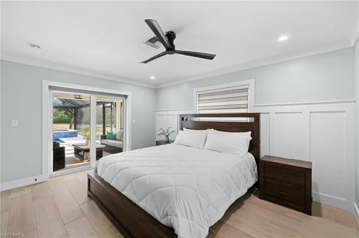 Bedroom with ceiling fan, light hardwood / wood-style floors, crown molding, and access to outside