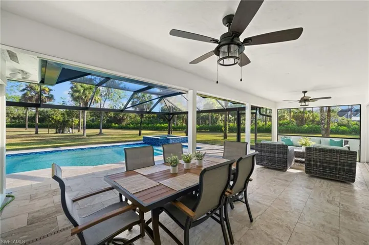 View of pool featuring an outdoor living space, a patio area, a lanai, and an in ground hot tub