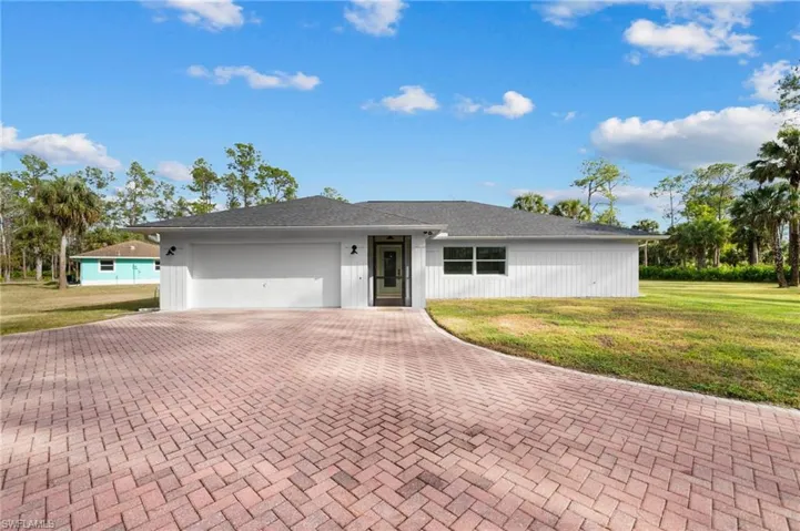 Main Home Ranch-style house with a front yard and a garage