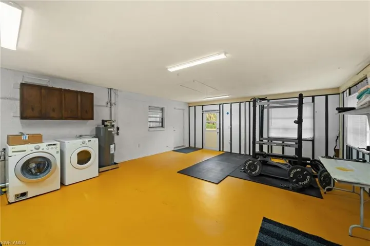 Guest House Exercise room featuring independent washer and dryer and water heater
