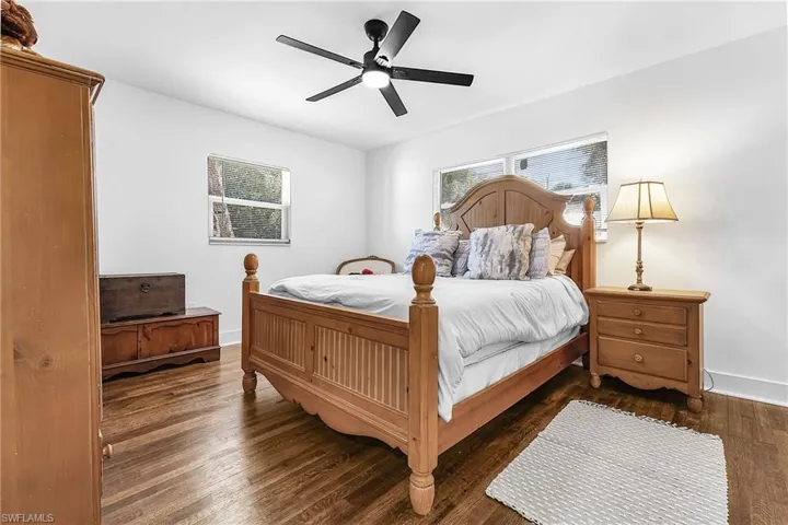 Bedroom with dark wood-style flooring and ceiling fan