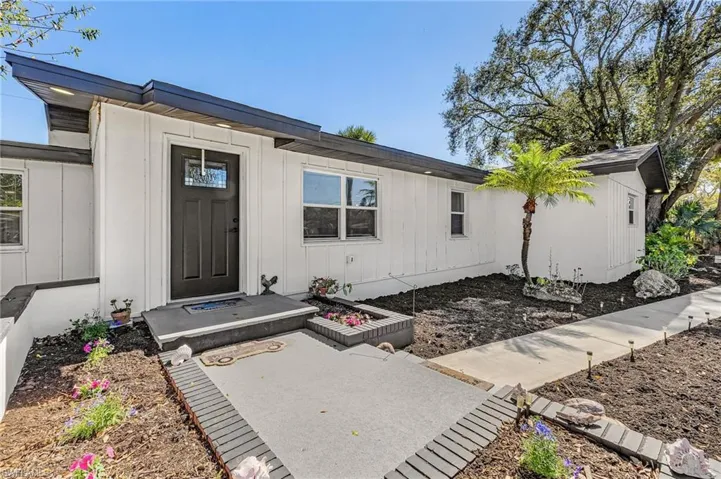 Doorway to property with a patio and board and batten siding