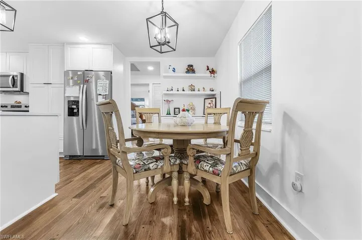 Dining room featuring a chandelier, dark wood-style floors, and recessed lighting