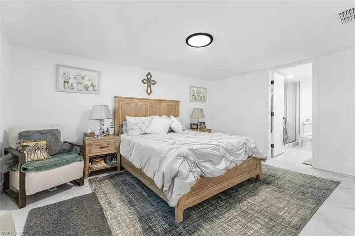 Bedroom with ensuite bath and baseboards