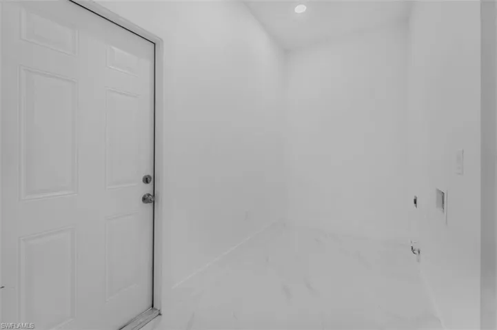 Bathroom with recessed lighting and light marble finish flooring