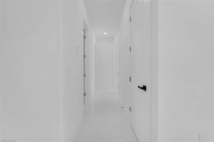Corridor with recessed lighting and light marble finish floors