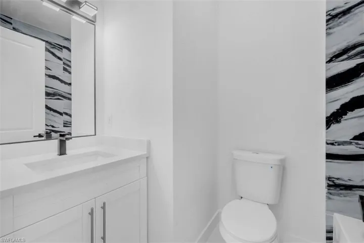 Full bathroom with vanity and toilet