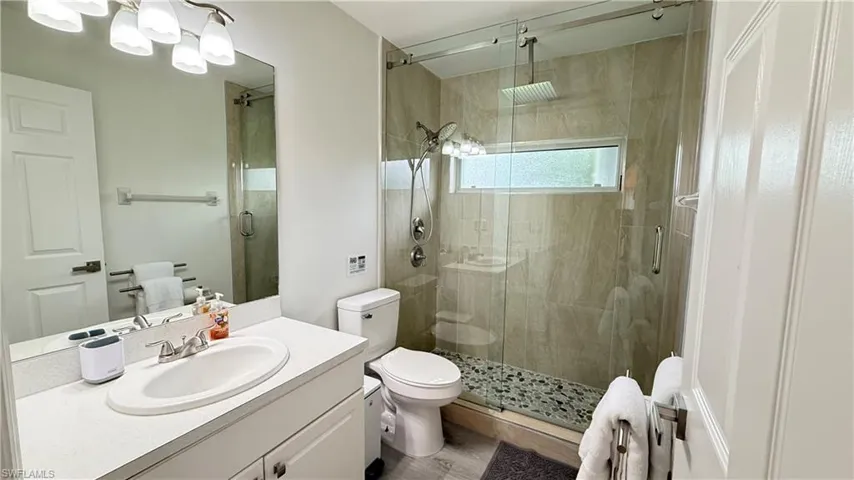 Bathroom featuring vanity and a shower stall