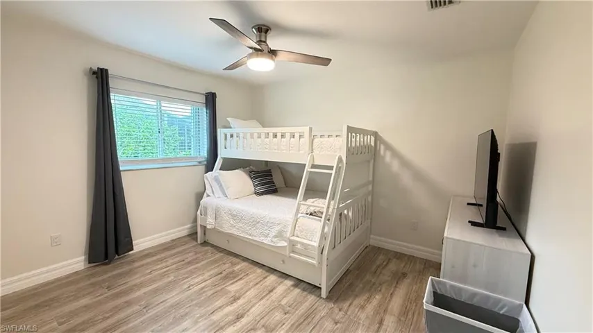 Bedroom with light wood-style flooring and a ceiling fan