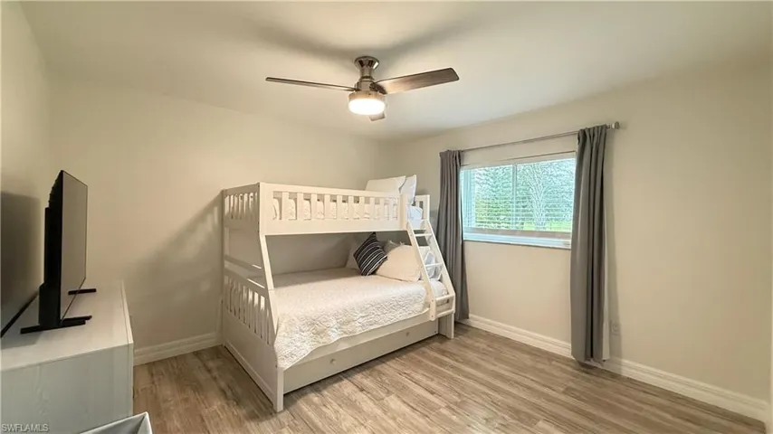 Bedroom featuring light wood-style floors and a ceiling fan