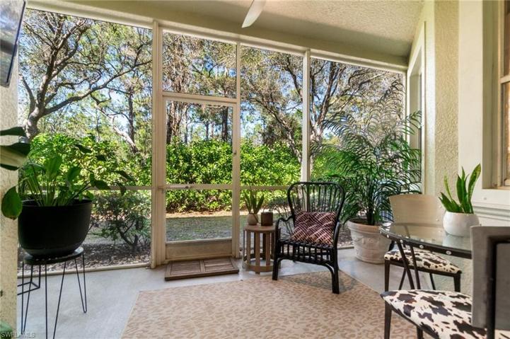 The screened in lanai overlooks a preserve area, offering a peaceful place to unwind.