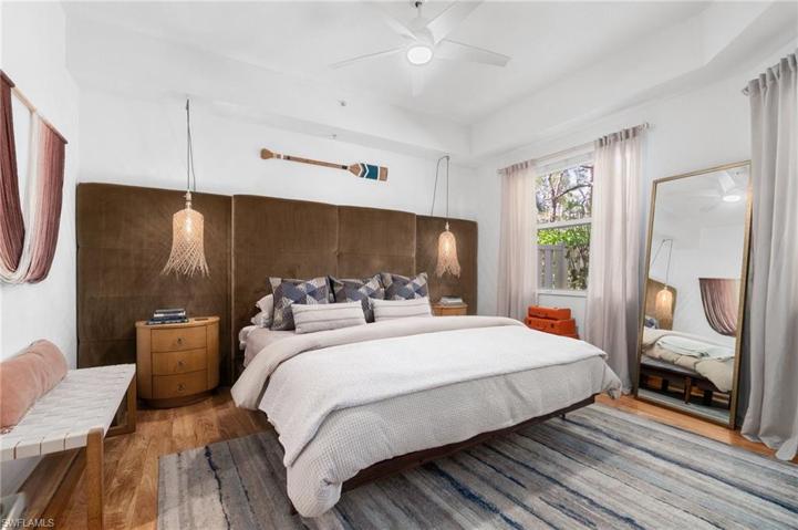 The primary suite boasts a custom wall-to-wall headboard, designer, boho chic light fixtures, new wood flooring, window coverings.  This custom suite invites you in to relax.