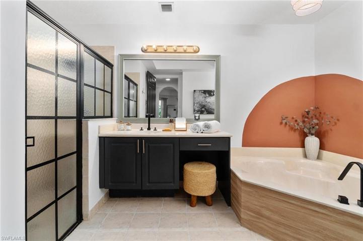 The primary bathroom has been touched with zen inspiration, complimented with a shoji shower door, decorative paint, and simplistic decor.
