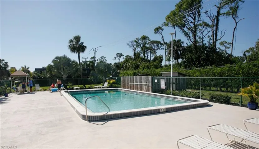 Rectangular swimming pool featuring a tiled waterline and integrated steps
