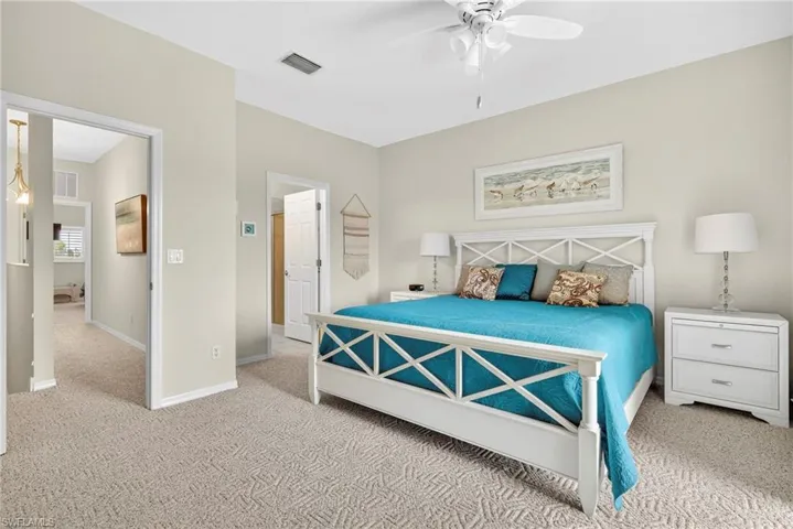 Bedroom featuring light carpet and a ceiling fan