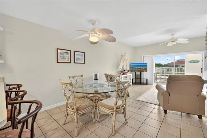 Dining room featuring light tile patterned floors and ceiling fan