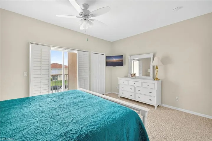 Bedroom with carpet floors, access to outside, ceiling fan, and a closet