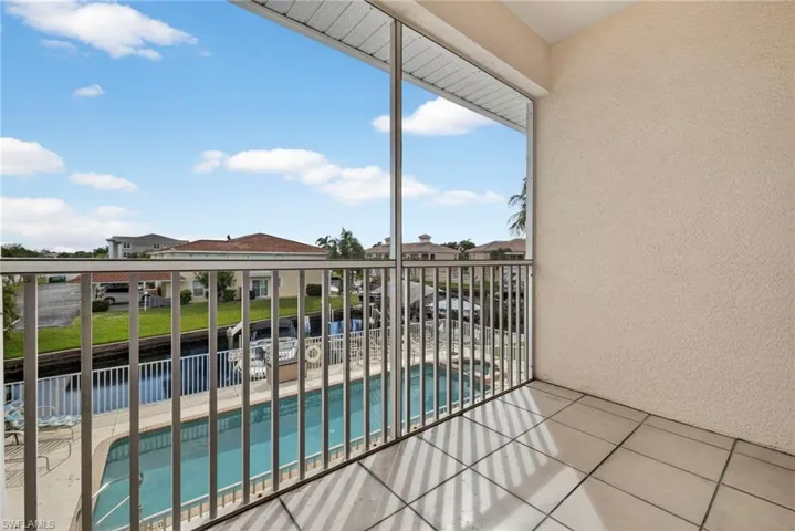 Balcony with view of pool area and a sunroom