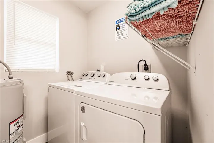 Laundry room with water heater and washing machine and dryer