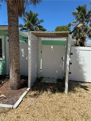 View of property exterior featuring a gate