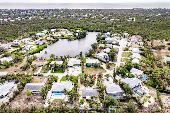 Aerial perspective of suburban area featuring a large body of water