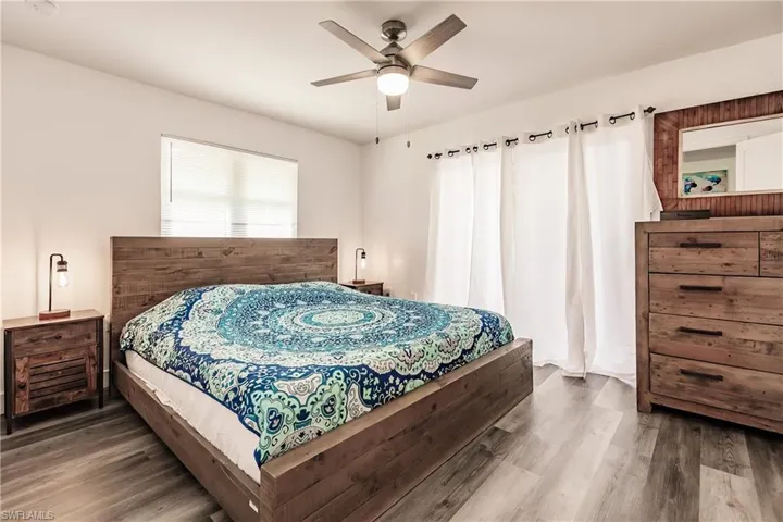Bedroom with dark wood-style floors and ceiling fan
