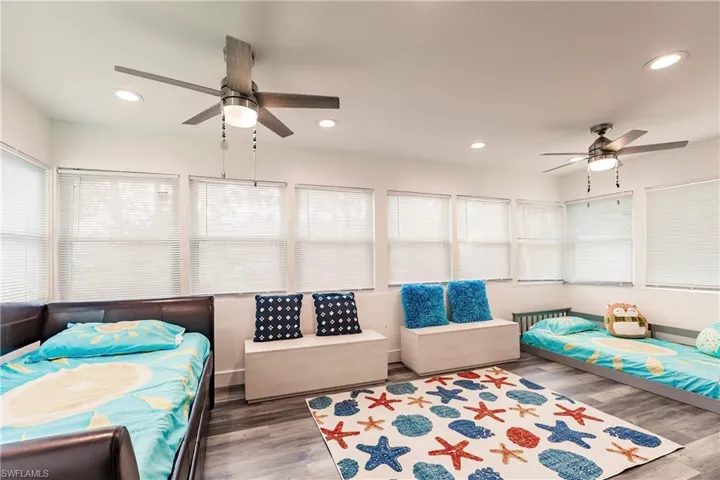 Bedroom featuring a ceiling fan, dark wood finished floors, recessed lighting, and multiple windows