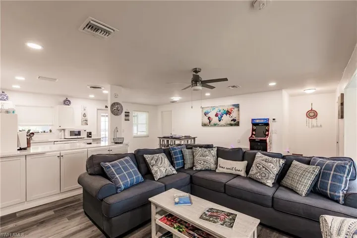 Living room featuring wood finished floors, a ceiling fan, and recessed lighting