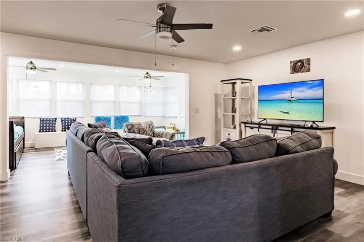 Living room with recessed lighting and wood finished floors