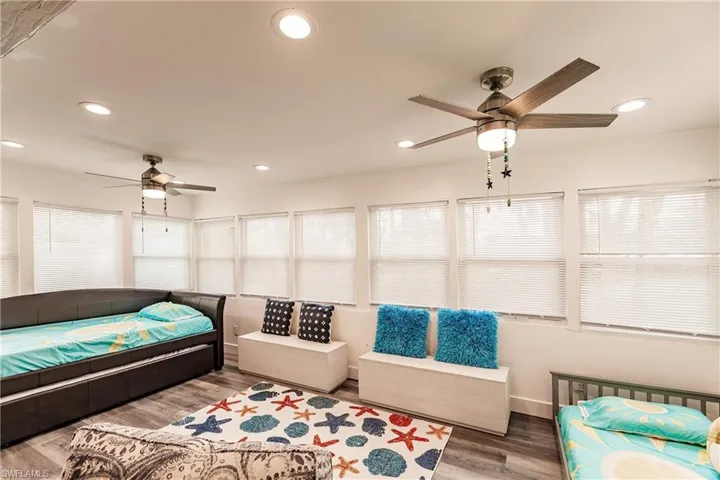 Bedroom featuring a ceiling fan, wood finished floors, and recessed lighting