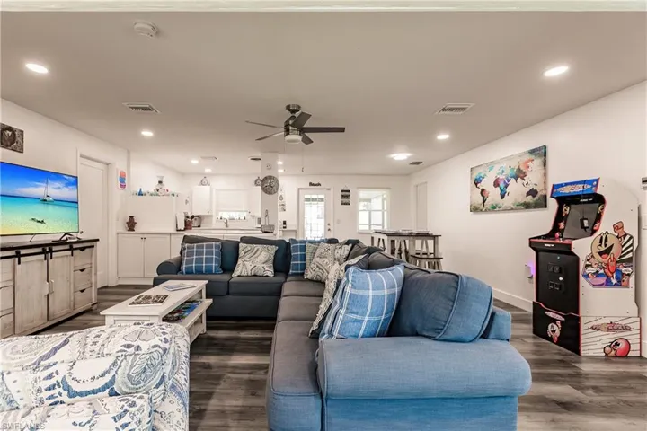 Living area featuring a ceiling fan, dark wood finished floors, and recessed lighting