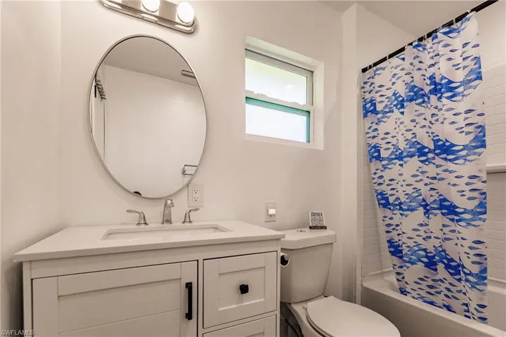 Bathroom with vanity and shower / tub combo