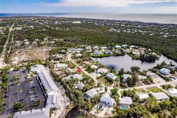 Aerial perspective of suburban area featuring a large body of water