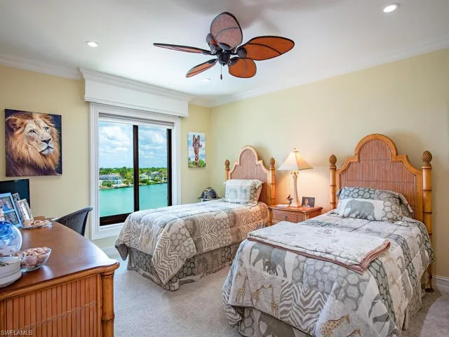 Carpeted bedroom featuring a ceiling fan, recessed lighting, and ornamental molding