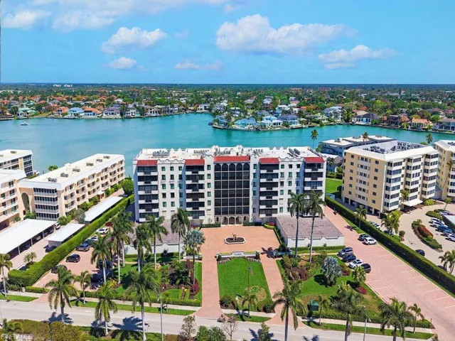 Drone / aerial view of a nearby body of water and apartment complex