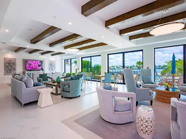 Living area with beamed ceiling and recessed lighting