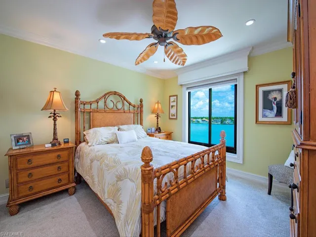 Bedroom with carpet floors, ornamental molding, a ceiling fan, and recessed lighting