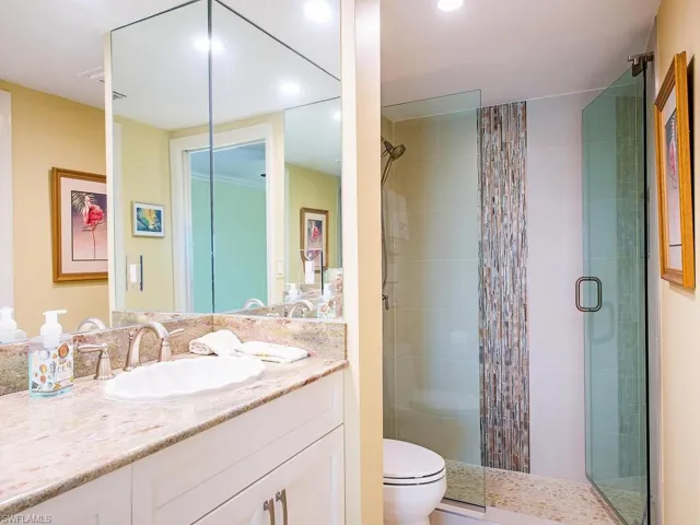 Bathroom featuring vanity and a stall shower