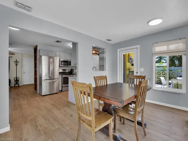 Dining area with light hardwood / wood-style flooring