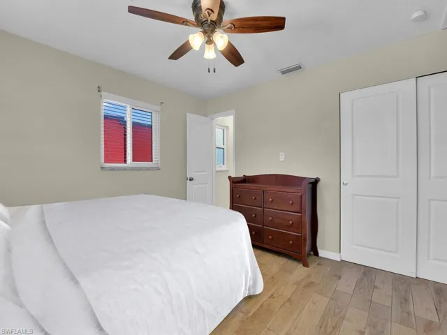 Bedroom featuring ceiling fan, a closet, and light hardwood / wood-style floors